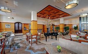 a lobby of a hotel with tables and chairs at Hotel Giraffe by Library Hotel Collection in New York