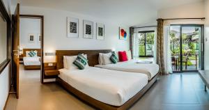 a bedroom with two beds and a balcony at Family House Zen Boutique Resort in Pai