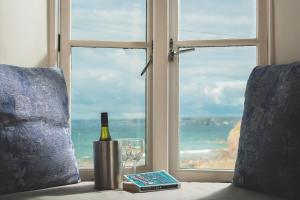 a bottle of wine and a glass and a window at Hope & Anchor in Hope Cove