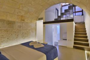 a bedroom with a bed and a staircase at Lonja Suites Apartments in Palma de Mallorca