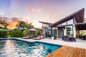 a home with a swimming pool and a house at Family House Zen Boutique Resort in Pai