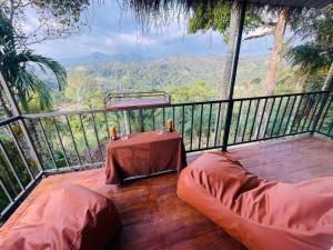 a deck with a table and chairs on a balcony at Ella Hillcrest Heaven-Free Pickup from Ella in Ella