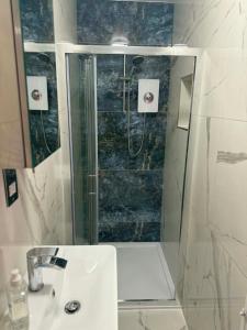 a bathroom with a shower and a sink at Harry Potter feature room- Warner bros studios in Watford