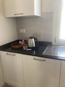 a kitchen counter top with a tea kettle on it at Villa sport relax in Colle di Val d'Elsa