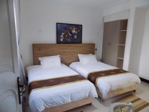 Postel nebo postele na pokoji v ubytování Remmings Hotel Kampala