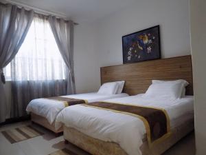 Postel nebo postele na pokoji v ubytování Remmings Hotel Kampala