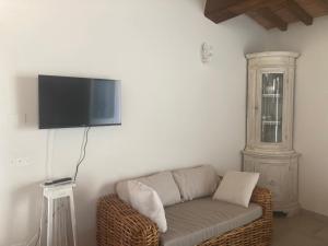 a living room with a couch and a flat screen tv at Villa sport relax in Colle di Val d'Elsa