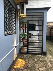 a door to a house with potted plants on it at AFRAAH GUEST House 2 in Yaoundé