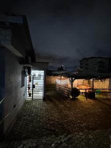 a door to a garage in a yard at night at AFRAAH GUEST House 2 in Yaoundé +2 photos