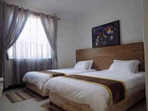 Postel nebo postele na pokoji v ubytování Remmings Hotel Kampala