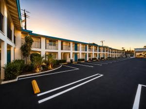 an empty parking lot in front of a building at Casa Blanca Hotel - Orange in Orange