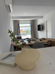 a living room with a table and chairs and a vase at Casa Bol Old Town in Bol