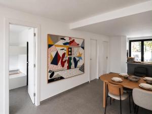a dining room with a table and a painting on the wall at Casa Bol Old Town in Bol