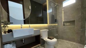 a bathroom with a toilet and a sink and a shower at Alcola Boutique Villa - Caspia Unit in Tlekung