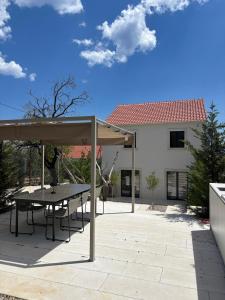 a patio with a table and an umbrella at Casa Bol Old Town in Bol