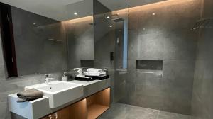 a bathroom with a sink and a shower at Alcola Boutique Villa - Caspia Unit in Tlekung +28 photos