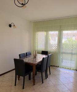 a dining room with a table and chairs at Shangai apartman in Belgrade
