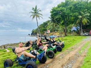 a group of people riding on quad bikes on the beach at La aldea in Capurganá
