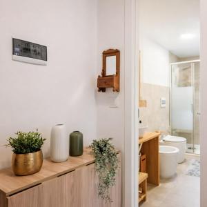 a bathroom with a counter with a toilet and a sink at Suite Bormio - with WIFI & Netflix in Piatta +4 photos