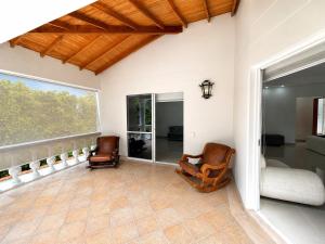 a living room with two chairs and a couch at La Toscana del Poblado in Medellín