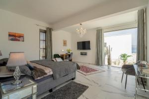 a bedroom with a bed and a living room at Villa Oasis mit Meerblick in Supetar