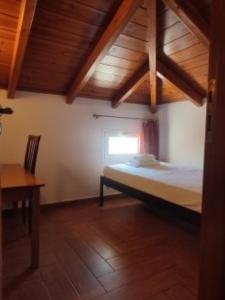 a bedroom with a bed in a room with a window at Kratounis Apartment 1 in Oikonomiánika