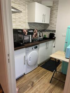 a kitchen with a washing machine and a counter at Naëlle in Calais
