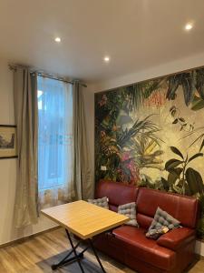 a living room with a couch and a table at Naëlle in Calais