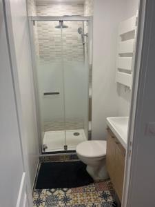 a bathroom with a shower and a toilet and a sink at Naëlle in Calais