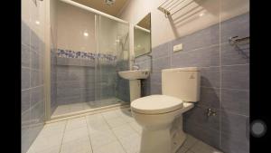 a bathroom with a toilet and a shower and a sink at Kenting Orange Homestay in Hengchun +37 photos