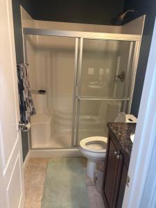 a bathroom with a shower and a toilet at The Abigail in Braselton