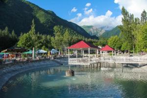 a body of water with a pier and mountains at Narınqala Hotel in Sheki