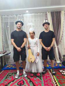 a group of three people wearing pirate hats and holding a guitar at Oskon Guesthouse in Kyzart