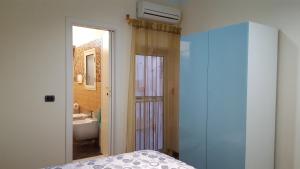 a bedroom with a bed and a bathroom with a sink at CasaLù in Palermo