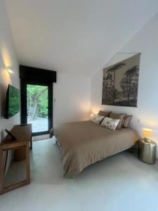 a bedroom with a large bed and a window at A Villa Rosa in Santa-Maria-di-Lota
