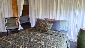 a bedroom with a bed and a chair at Partsi Veski in Partsi