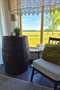 a room with a chair and a table and a window at Partsi Veski in Partsi