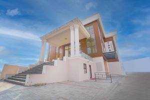 a building with stairs in front of a building at YAFA Palace in Rāmanāthapuram