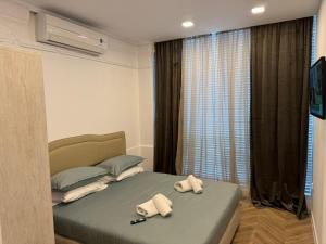 a bedroom with two towels on a bed at Tempo apartments in Pazardzhik