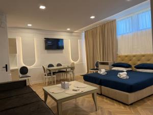 a hotel room with two beds and a table at Tempo apartments in Pazardzhik