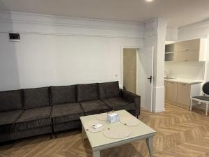 a living room with a couch and a table at Tempo apartments in Pazardzhik