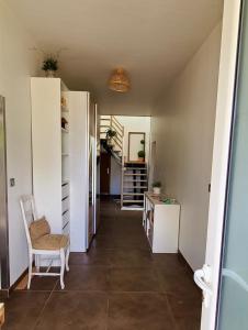 a hallway of a house with a chair and a table at Métairie du Peyré in Pauilhac +7 photos