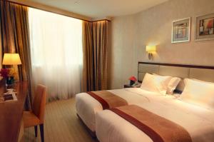 Voodi või voodid majutusasutuse Grandview Hotel Macau toas