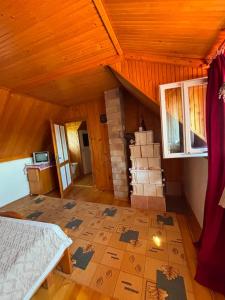 an attic room with a bed and boxes on the floor at Casa cu şemineu in Păuşa