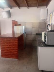 a kitchen with a counter top in a room at Casa Amarilla in Luján