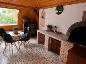 a living room with a table and a fireplace at Casa cu şemineu in Păuşa