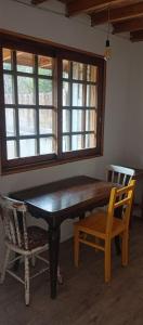 a dining room table with two chairs and a window at Casa en Marindia Sur in Salinas