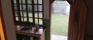 a kitchen with a sink and a view of a yard at Casa en Marindia Sur in Salinas +5 photos