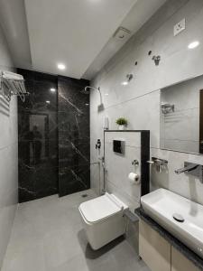 a bathroom with a toilet and a sink and a shower at Hotel RajKailash in Jaipur