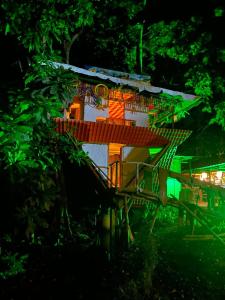 a house with a staircase leading up to it at night at La aldea in Capurganá +10 photos